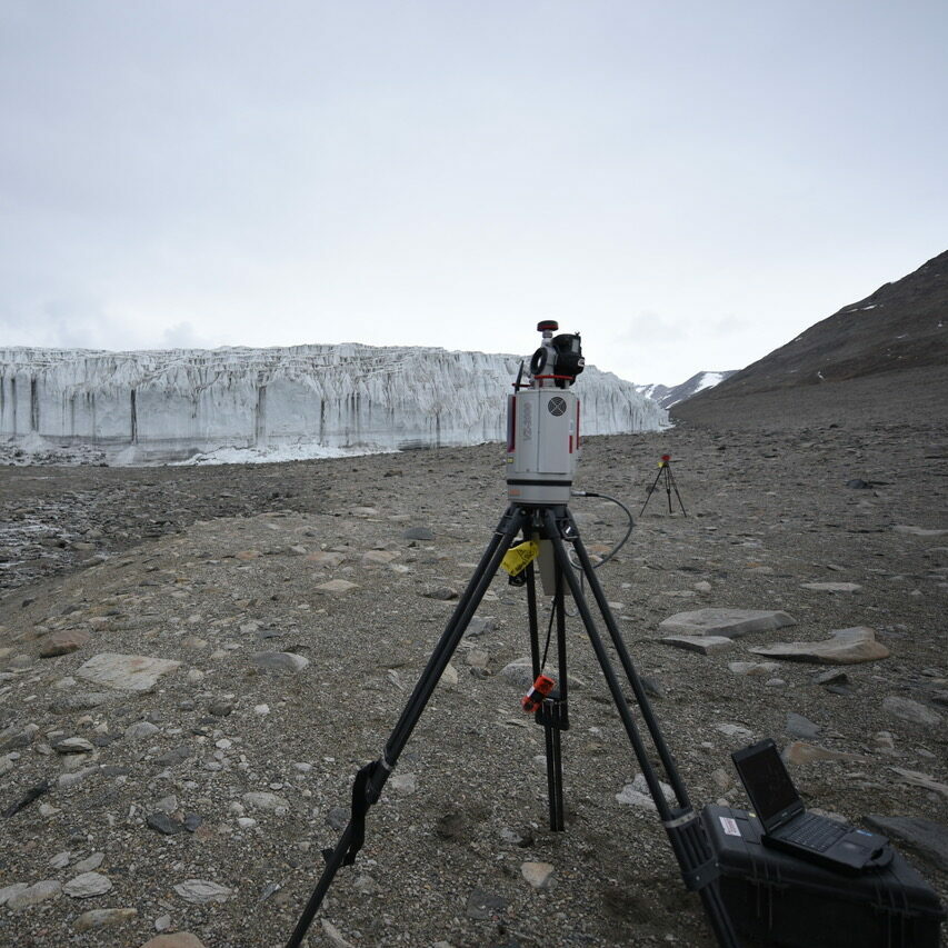 terrestrial laser scanner on tripod with Antarctic glacier in background