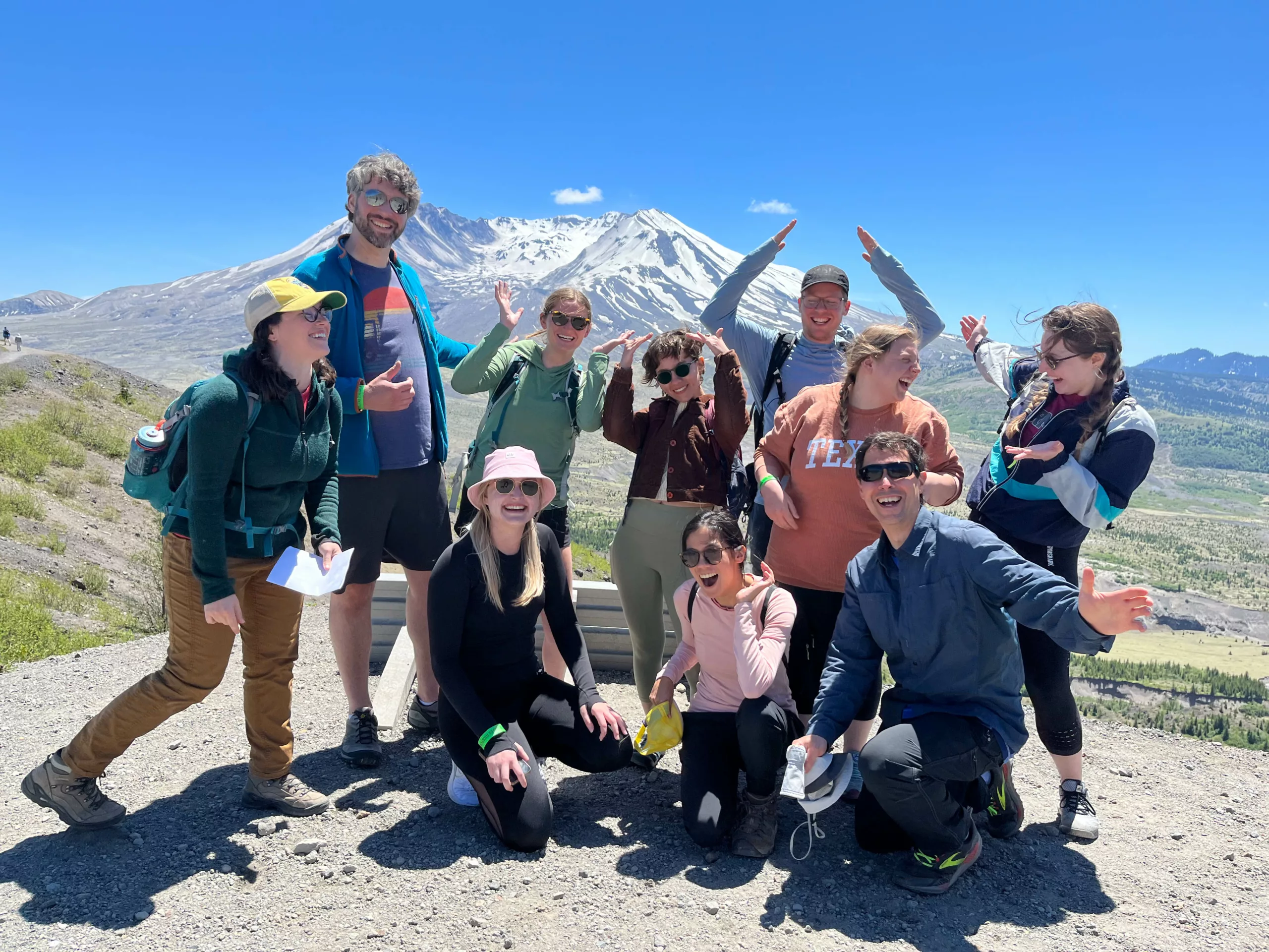 interns and mentors pose for a photo with Mount St. Helens in the background