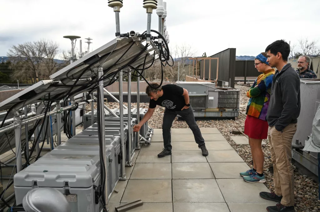 staff looking at test equipment on a rooftop