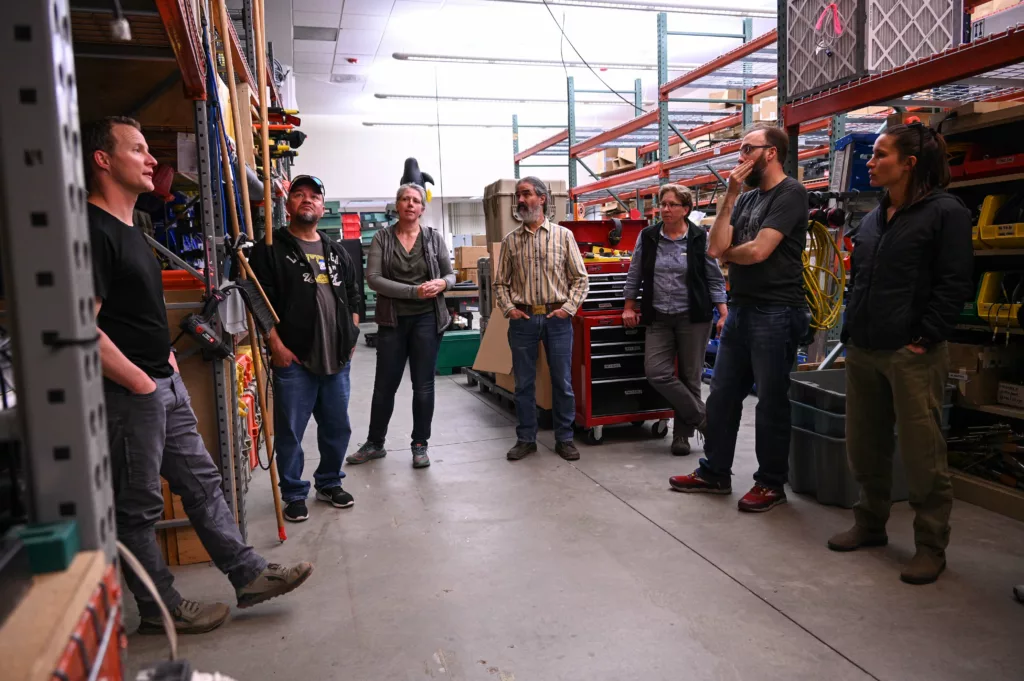 staff conversing in front of equipment