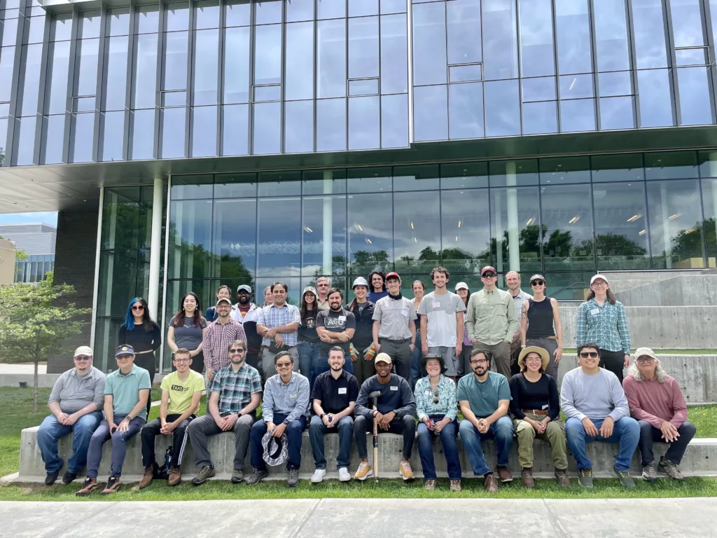 group photo in front of glass building