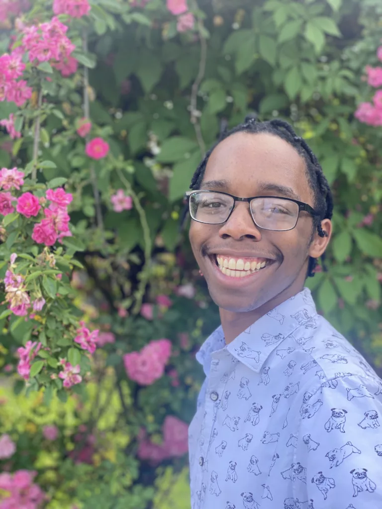 RESESS intern Rori smiling with green foliage in the background.