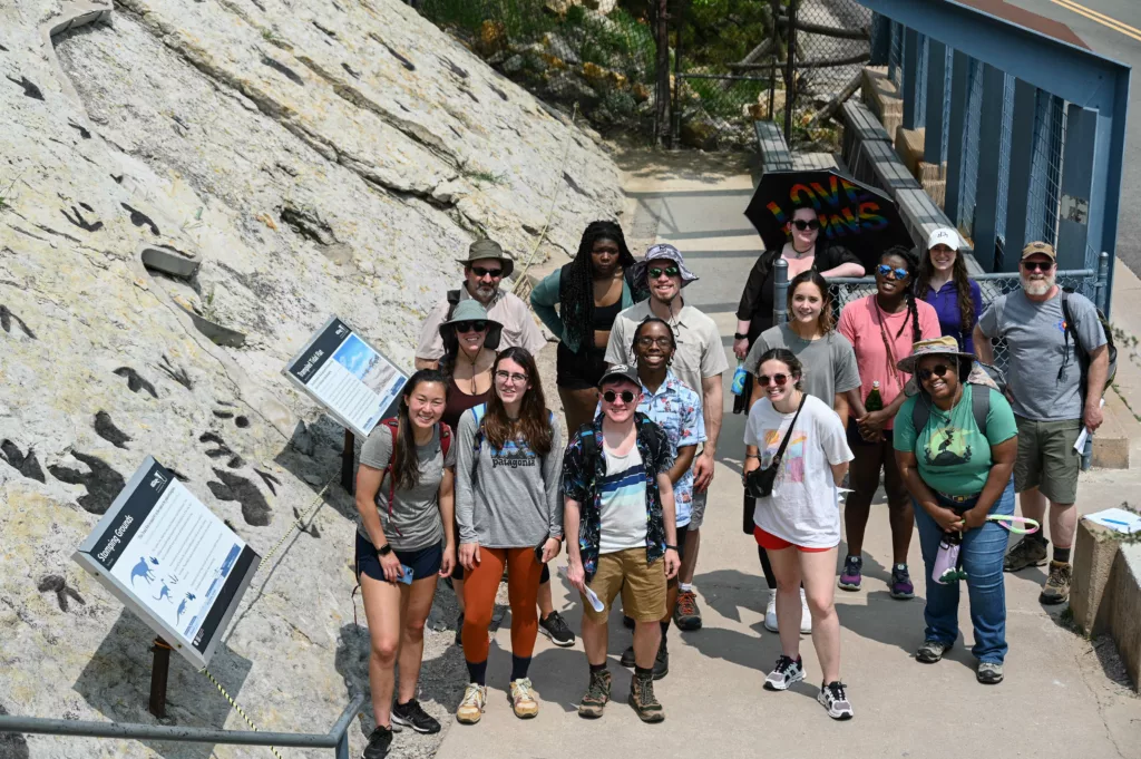 interns group photo in front of dinosaur trackway