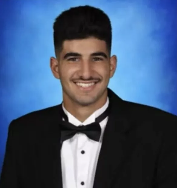 RESESS intern Hassan Saleh in a suit with a blue background.