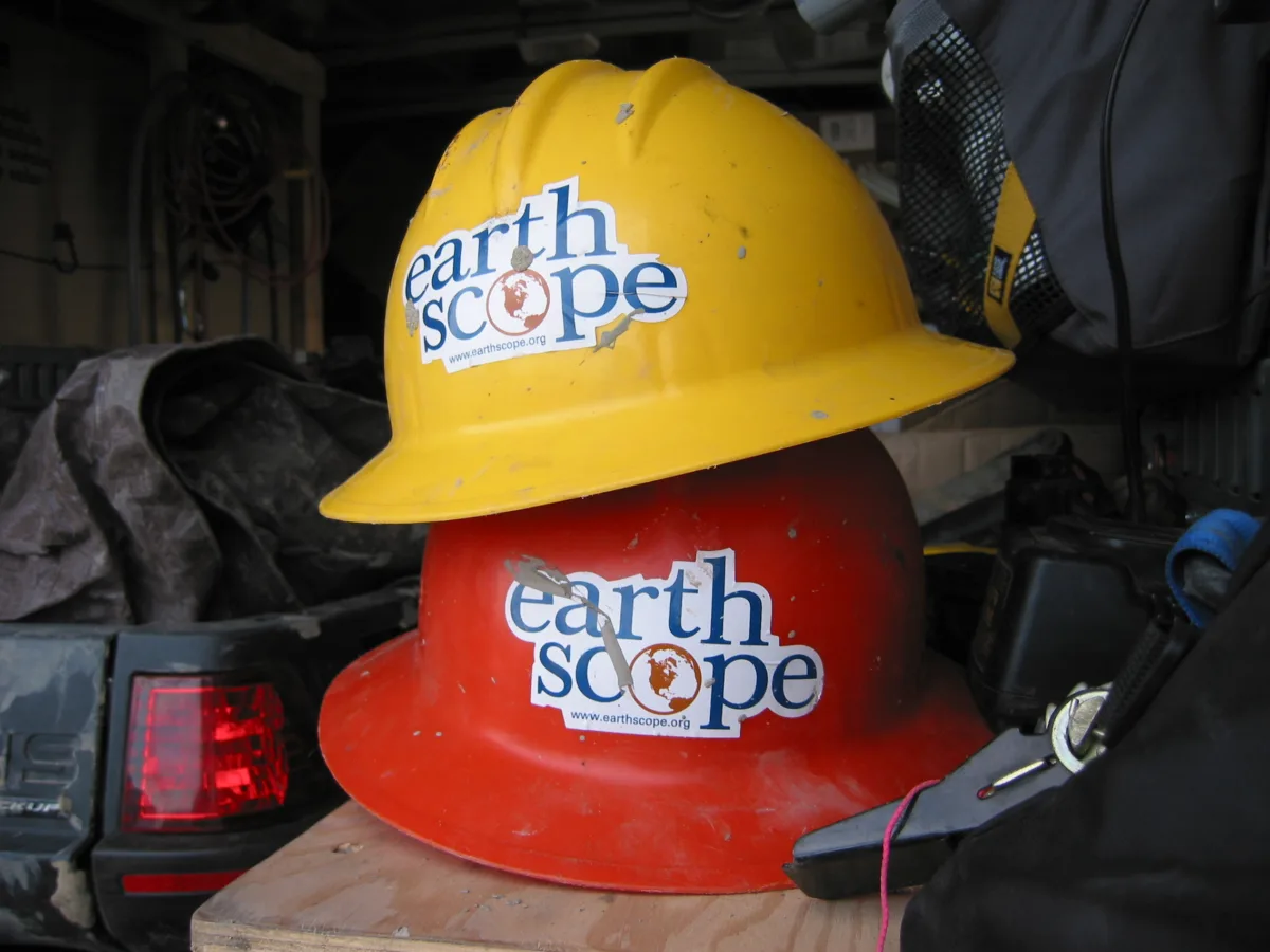 Two hardhats with earthscope program stickers on them.