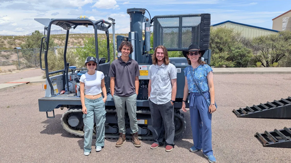 Dylan (second from left) poses with three other interns in front of heavy machinery used for active source siemology
