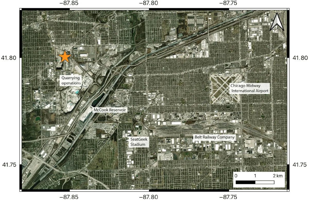 Aerial photo with labels marking a quarry, reservoir, stadium, railway company, and airport.