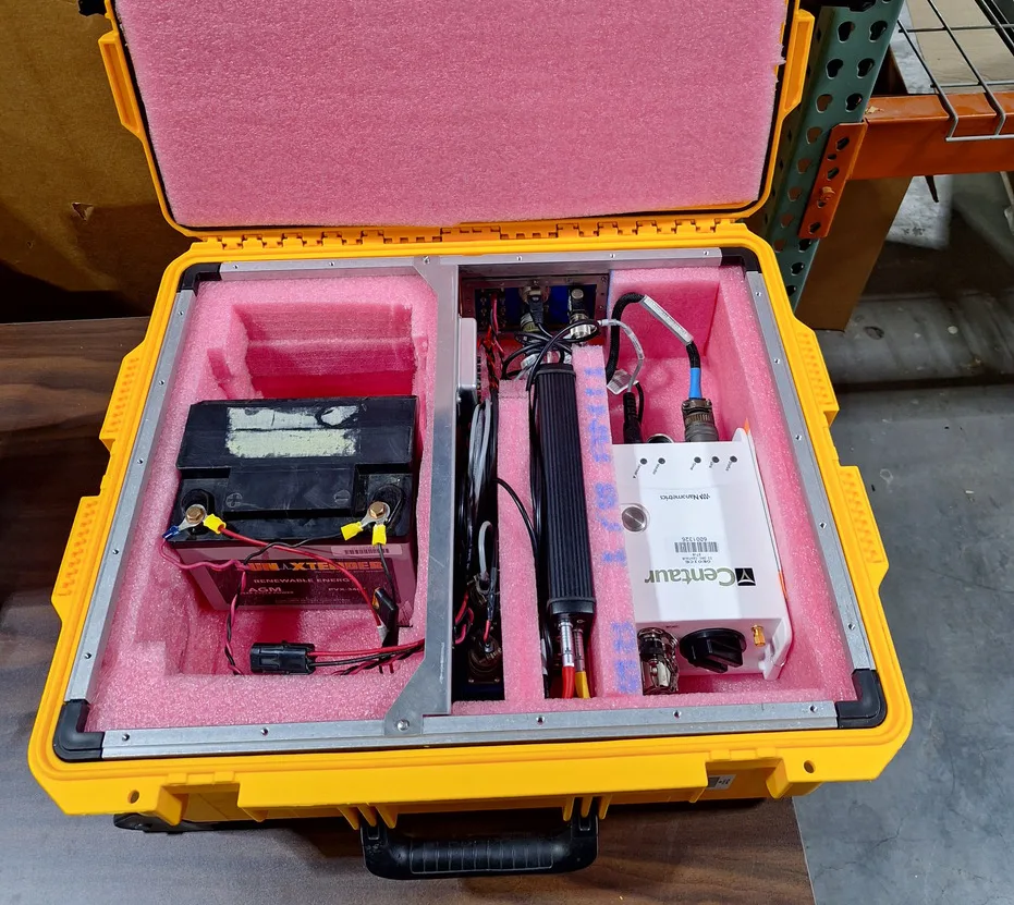 Opened yellow bow with pink padding foam inside securing internal station components