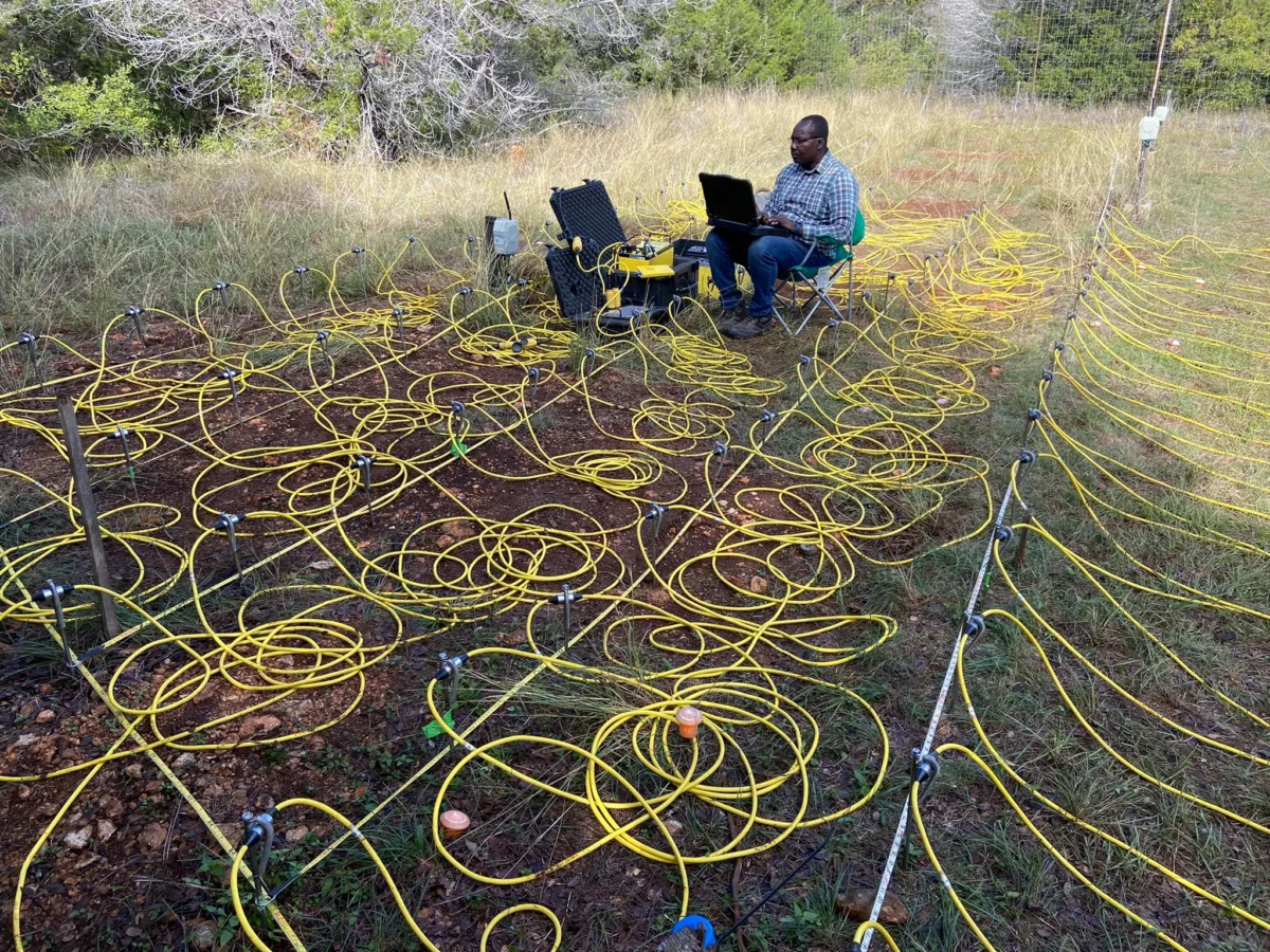 ERT components strewn across and grassy lawn with rows of electrodes.
